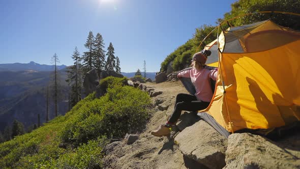 Yosemite National Park. Nice Sunny Day. A Girl Watches the Landscape Through the Binoculars.