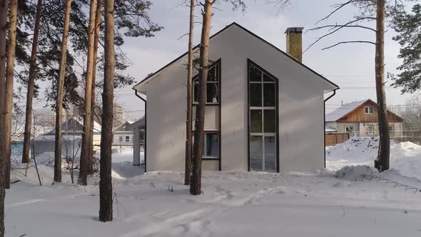 Drone shot of new white modern residential house at winter 05