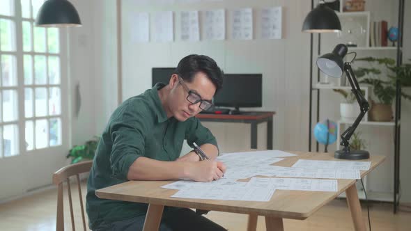 Asian Man Drawing Storyboard Animation Comic Cartoon, Design Creative Scene Layout At Studio