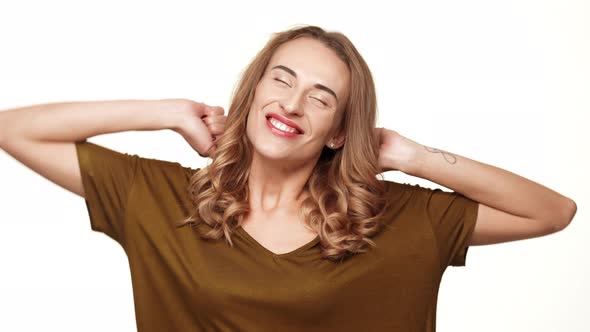 Charming Middleaged Female with Long Brown Hair Yawning Stretching and Smiling on White Background