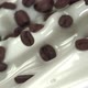 Flying coffee beans mix into flowing milk in slow motion. Close up - VideoHive Item for Sale