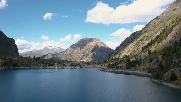 Soft drone orbit shot of Lake Lauvitel. In the background the Venosc mountains, Les Deux Alpes, Fran