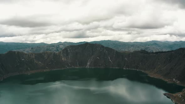 Quilotoa Crater In Ecuador On A Cloudy Day - aerial pullback