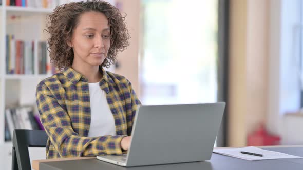 Attractive Mixed Raced Woman with Laptop Smiling at Camera