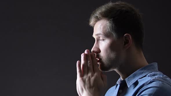 Light Falling on Man Praying Faithfully to God, Belief in Changes for Better