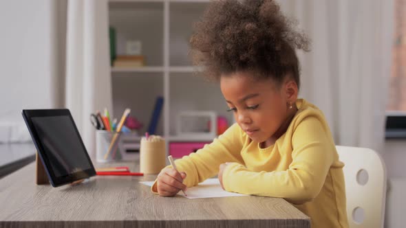Little Girl Drawing with Coloring Pencils at Home