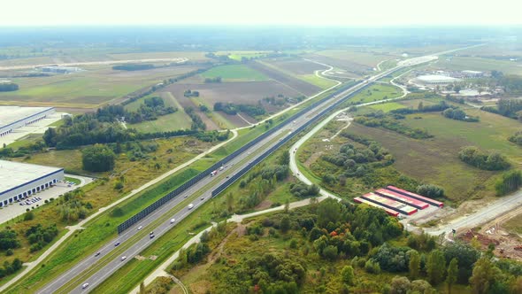 Aerial view of logistics center, warehouses near the highway. Delivery center Traffic