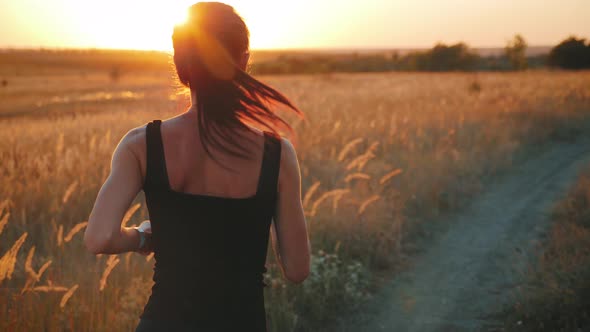 Young Fitness Sport Woman Running on Road at Sunset. Athlete Runner Feet Running on Road, Slow