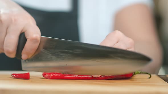 Close Up Female Kitchener Hand Cutting Red Spice Pepper