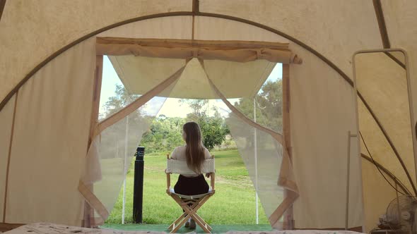 Travel Camping Woman Sitting at Outside of Tent Relax and View on Nature and Wild Animals