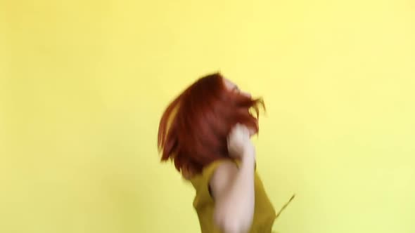 Emotional Girl with Red Hair Shouting Over Yellow Background