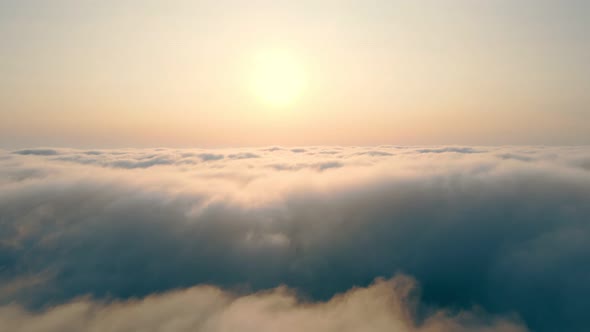 Fabulous Sunrise Over the Clouds. Flight Over the Morning Fog Above the Sky and Sunbeams That