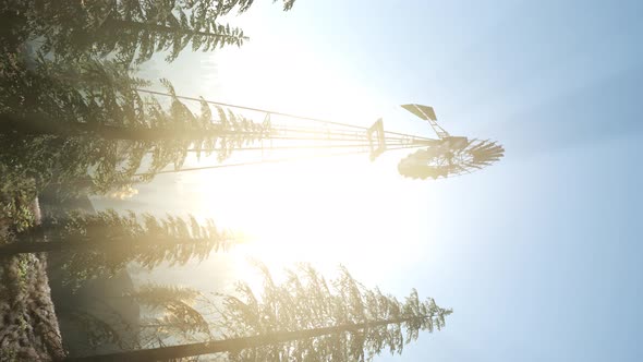 Typical Old Windmill Turbine in Forest. Vertical Format