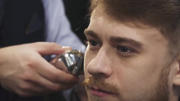 Young Man Getting a Gaircut at the Barbershop