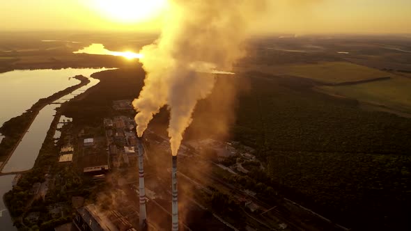 Smoking industrial pipes. Aerial view of old factory with pipes