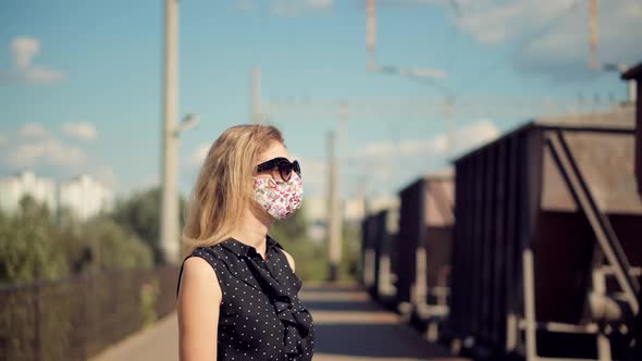 Female Waiting Train Wearing Protective Mask COVID19 Virus. Health And Safety Concept.