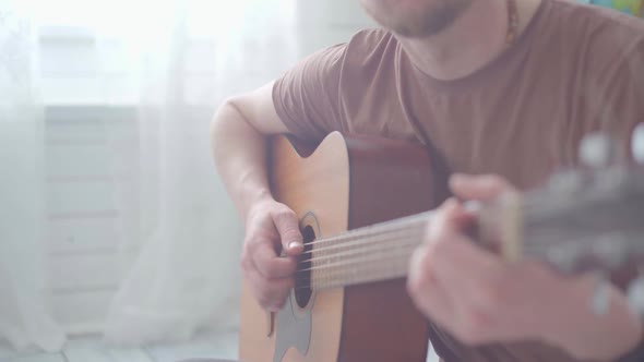 A Man Playing the Guitar