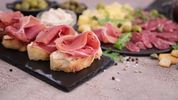 Bruschetta with Prosciutto or Jamon Ham and Cream Cheese on Stone Serving Board