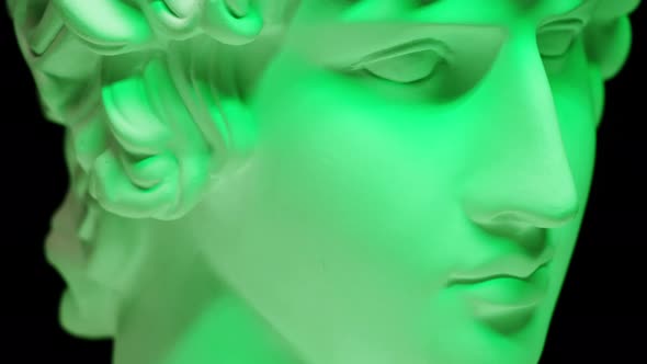 Plaster Head Sculpture Apollonian in Green Neon Light Closeup