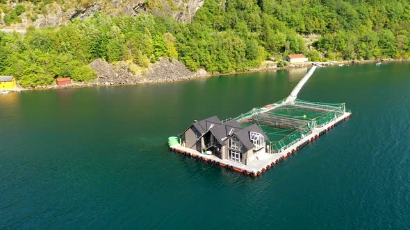 Cinematic Aerial view of a fish farm in Fjord of Norway