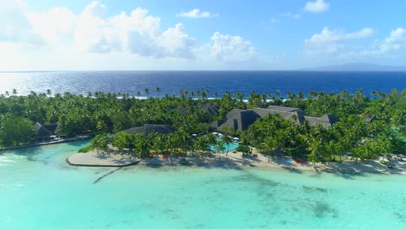 Aerial drone view of a luxury resort and pool in Bora Bora tropical island.