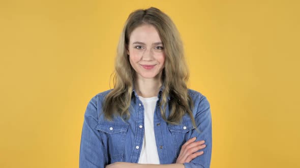 Portrait of Young Smiling Pretty Girl on Yellow Background