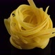 Raw Italian Pasta tagliatelle on black background, rotation - VideoHive Item for Sale