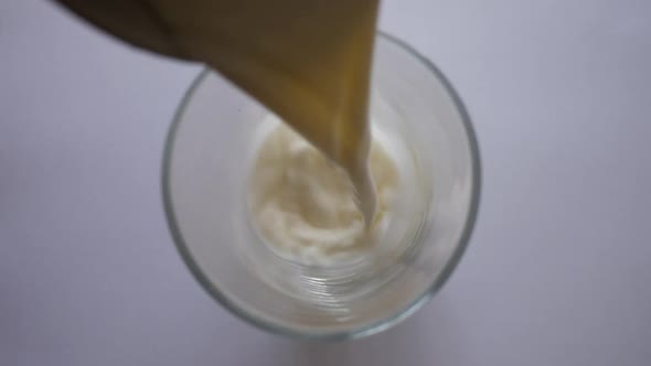 Full Cream Milk Poured Into A Drinking Glass. TOP DOWN VIEW