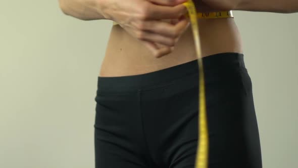 Anorexic Girl Measuring Waist With Tape-Line and Showing Ok, Insecurities