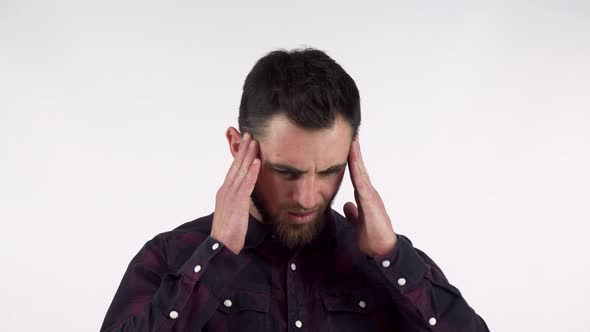 Bearded Young Man Suffering From Terrible Headache, Rubbing His Temples