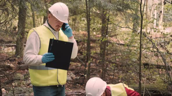 Man Woman Environmentalists Document Offense  Forest Pollution and Issue Fine