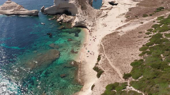 Aerial View of White Bluff Beach on Bay on the Coastline with Waves in the Blue Sea