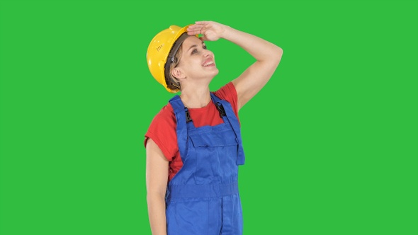 Engineer construction worker woman looking up at something