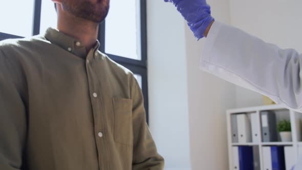 Doctor Checking Male Patient's Throat at Hospital