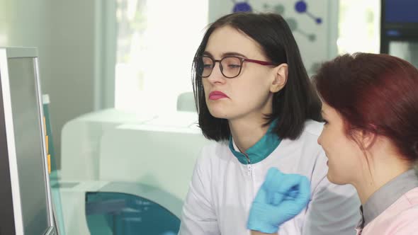 Female Scientist Talking To Her Colleague