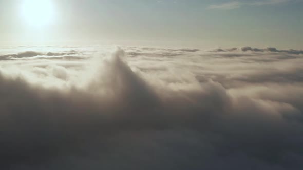 Flying Over the Evening Clouds with the Late Sun.