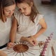 Smiling Woman Teaching Paper Vine Basket to Daughter at Home - VideoHive Item for Sale