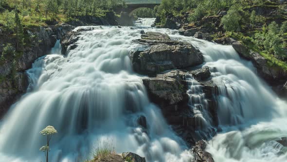 Long exposure time lapse of waterfall in scenic landscape (loopable)