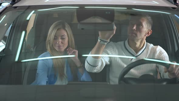 Thoughtful Man and Woman Sitting in Car with Cute Girl Entering Sitting on Back Seat