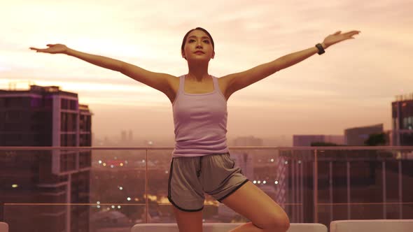 View of Young asian Woman Sitting on Mat and Practicing Yoga and Meditation