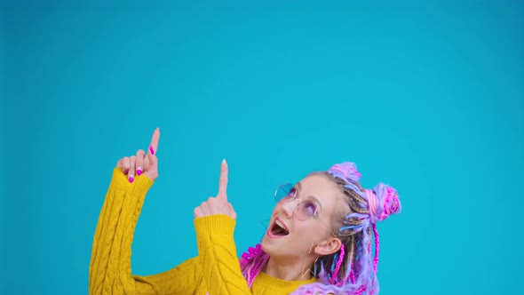 Young Colorful Girl Pointing to the Left Part of Screen for Logo or Title