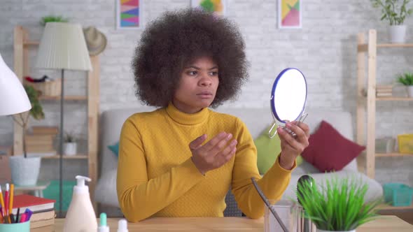 Portrait African American Woman with an Afro Hairstyle of That Unhappy Looking in the Mirror Finds a