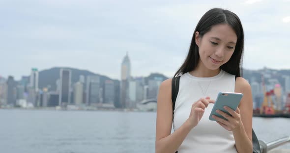 Woman using cellphone in the city 