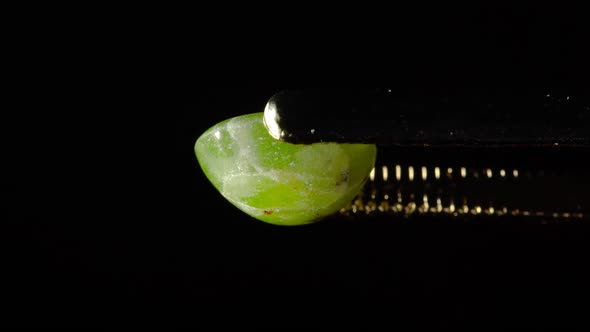 Natural Hydrogrossular Green Garnet in Tweezer on Turn Table