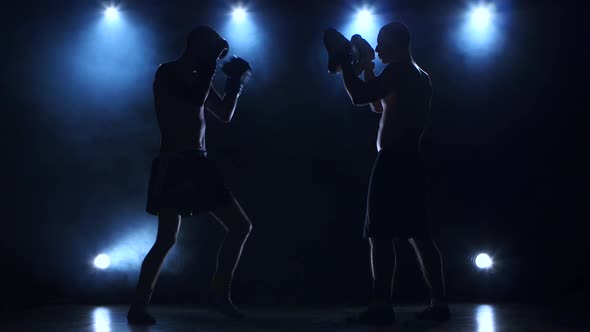 Two Boxers Are Working To Blows. Silhouette of Young Sportsmen