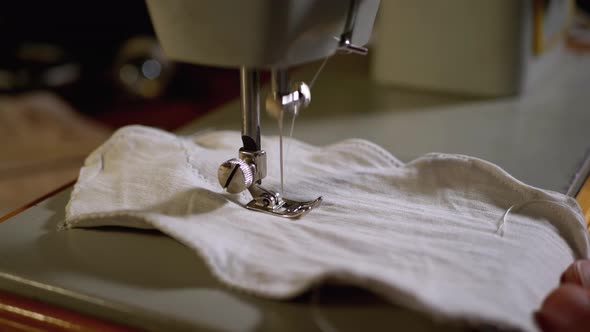 A Tailor Sews Homemade Face Mask of Fabric