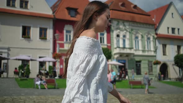 Townswoman of Small Slovakian Town Bardejov is Walking on Main Square