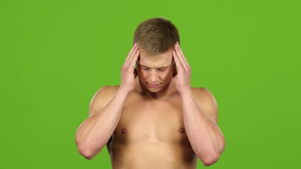 Man with Headache Is Massages His Temples Hands, Green Screen