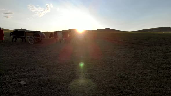 Central Asian Family People Walking Immigrating With Traditional Old Oxcart Tumbrel And Tumbril Cart