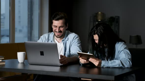 Two young people are discussing and preparing the contract. It is a business meeting